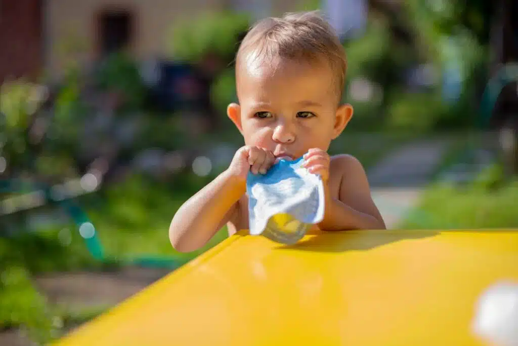 Close up of a young child eating from a puree pouch, representing the WanaBanda FDA warning.