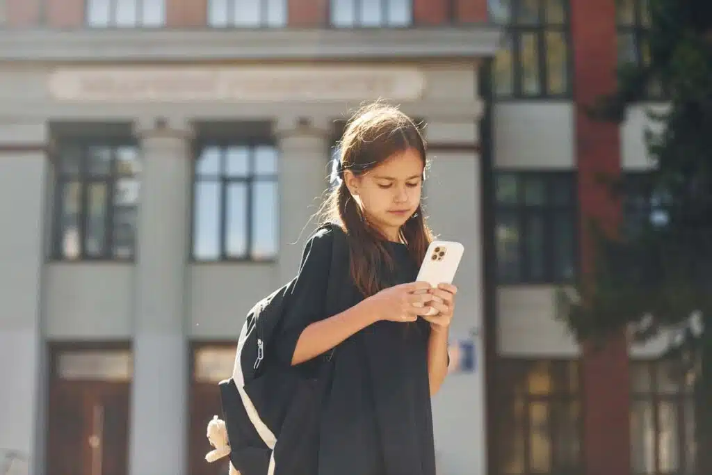 Close up of a young girl using a smartphone, representing the social media multidistrict legislation.