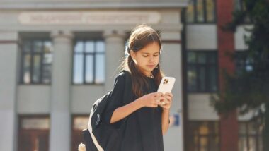 Close up of a young girl using a smartphone, representing the social media multidistrict legislation.