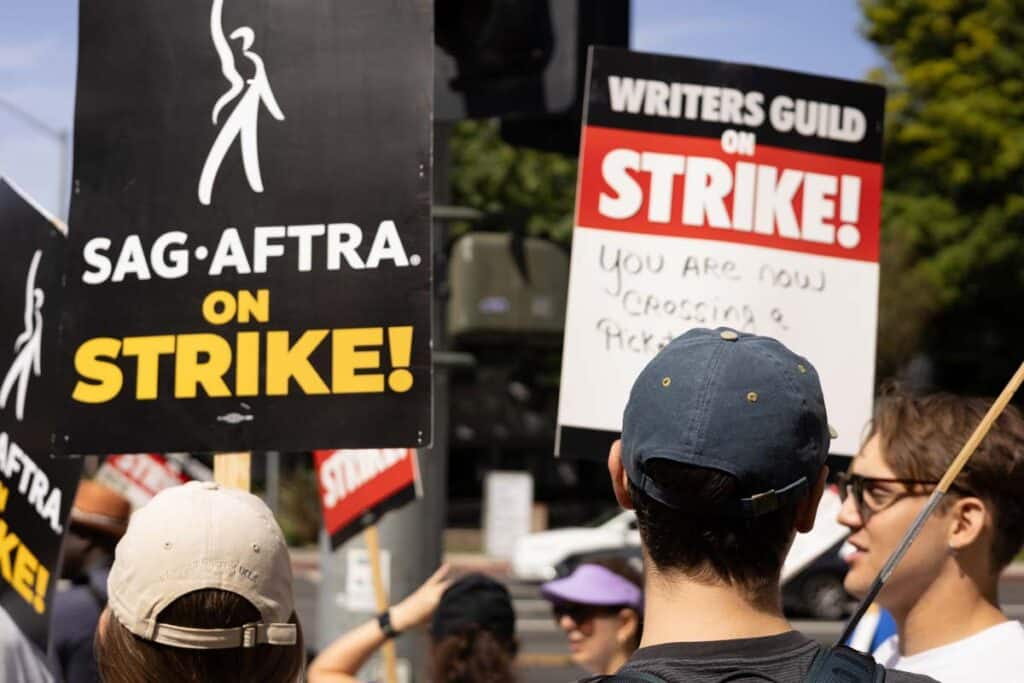 Protestors holding SAG-AFTRA strike signs, representing the SAG-AFTRA deal.