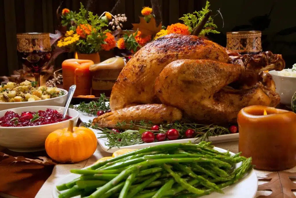Close up of a Thanksgiving meal on a dinner table, representing Thanksgiving dinner cost.