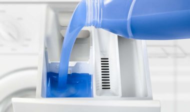 Close up of laundry detergent being poured into a washing machine, representing the Persil detergent class action.