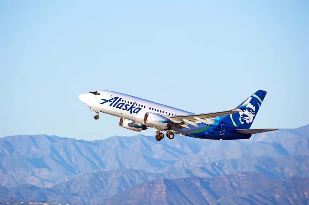 An Alaska Airlines aircraft in the sky, representing the Alaska Airlines class action.
