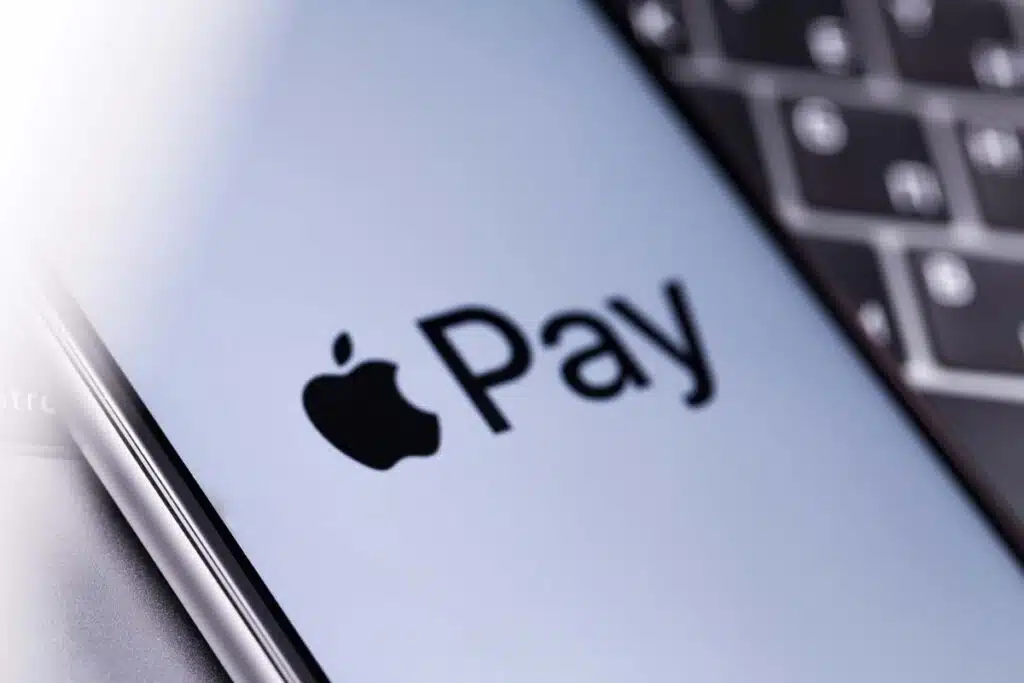 Close up of Apple Pay logo displayed on a smartphone screen, representing the Apple, Mastercard and Visa lawsuit.