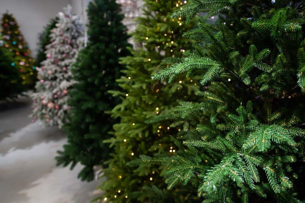 A row of artificial trees in a store, representing Americans' fake tree use.