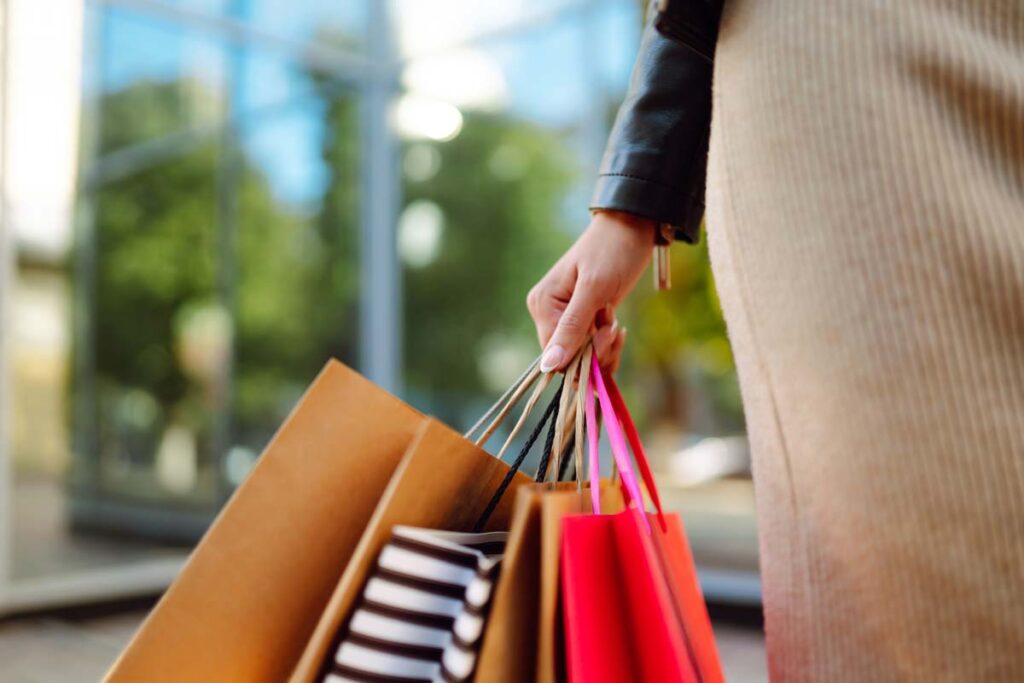 Close up of a woman holding shopping bags, Top recalls for the week of Dec. 11 include Ford vehicles, Polaris snowmobiles.