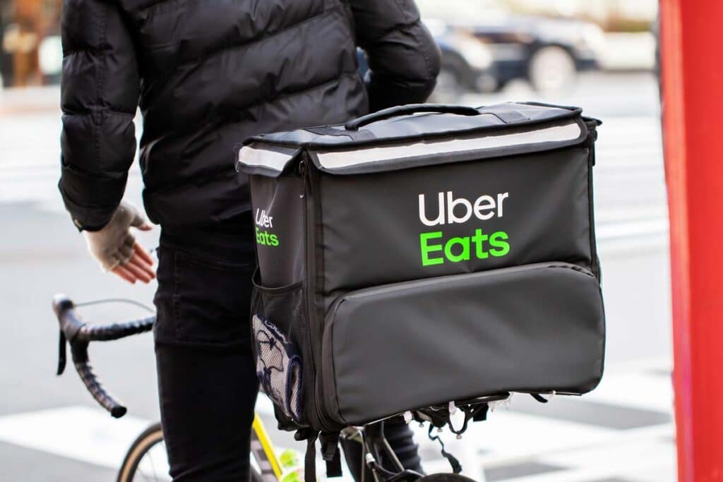 Close up of an Uber Eats delivery bag on the back of a bicycle, representing the New York City Uber Eats settlement.