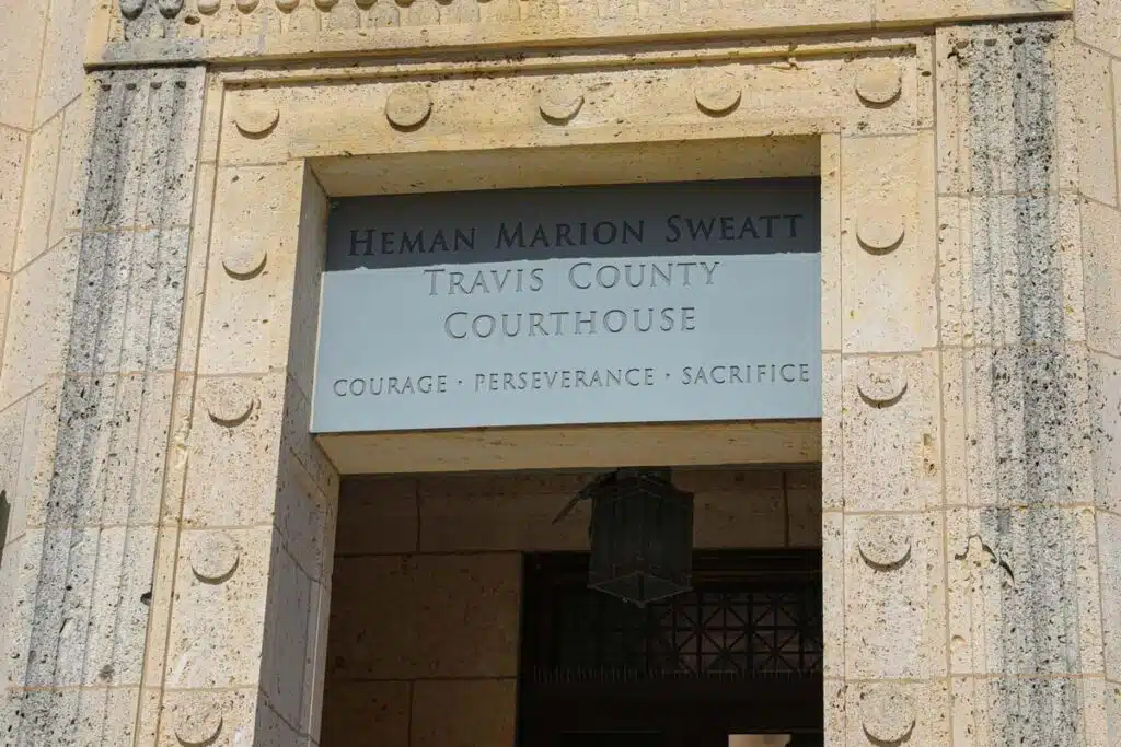 Close up of Travis County Courthouse entrance, representing the Texas abortion ban lawsuit.