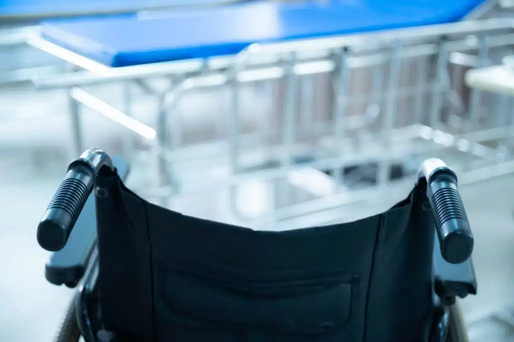 Close up of a wheelchair in front of a surgical table, representing the Barnet Dulaney Perkins Eye Center settlement over alleged violations of the Americans with Disabilities Act