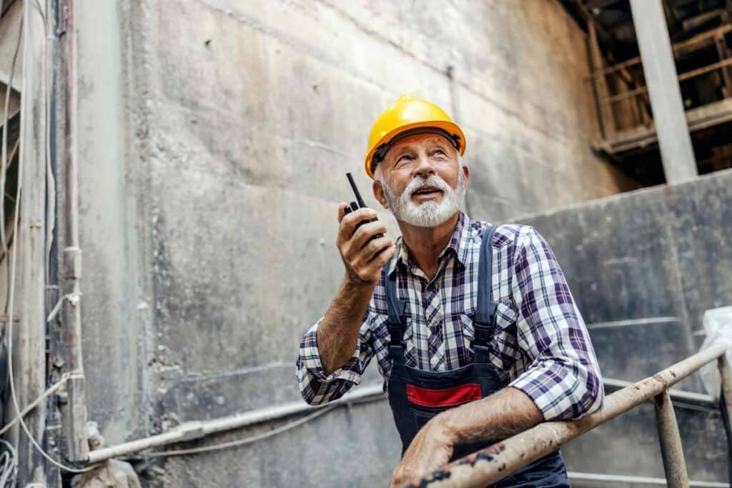 An elderly worker working at a job site, representing older workers and older workers' earning potential.