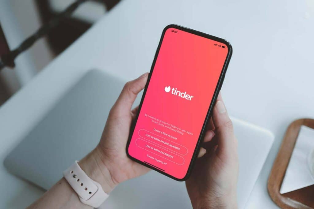 Close up of the Tinder app displayed on a smartphone screen, representing the Tinder age bias settlement.