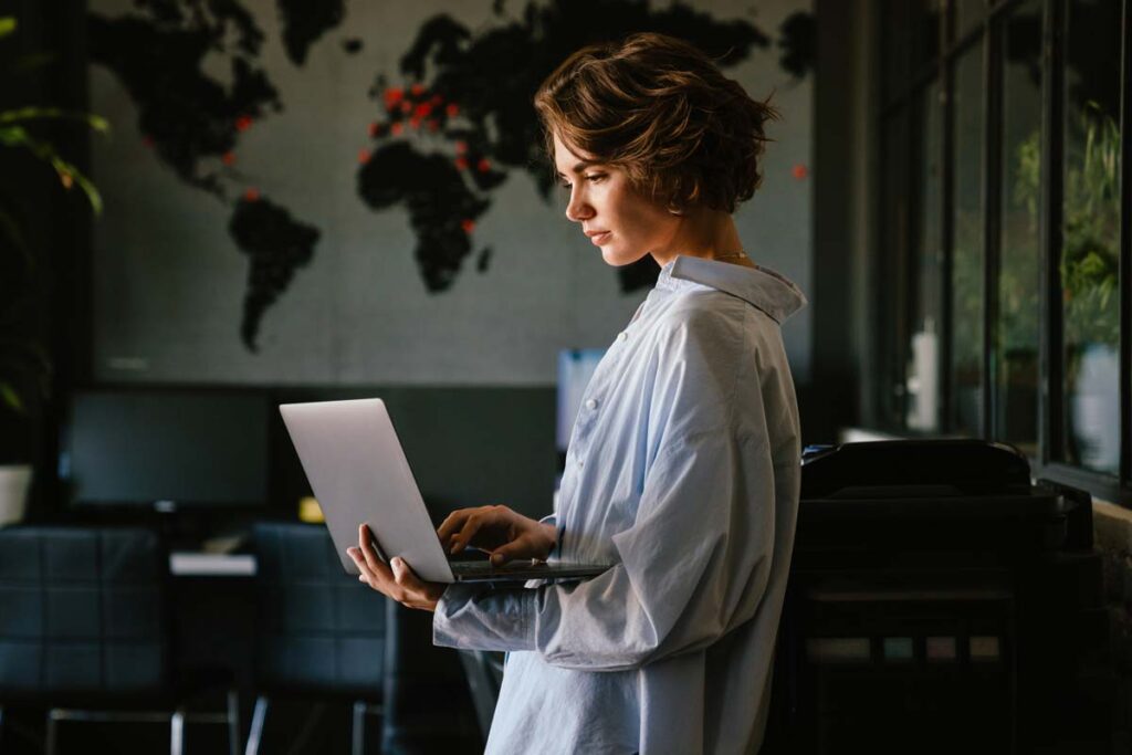 A woman using a laptop in her home, representing the Spokeo privacy class action.