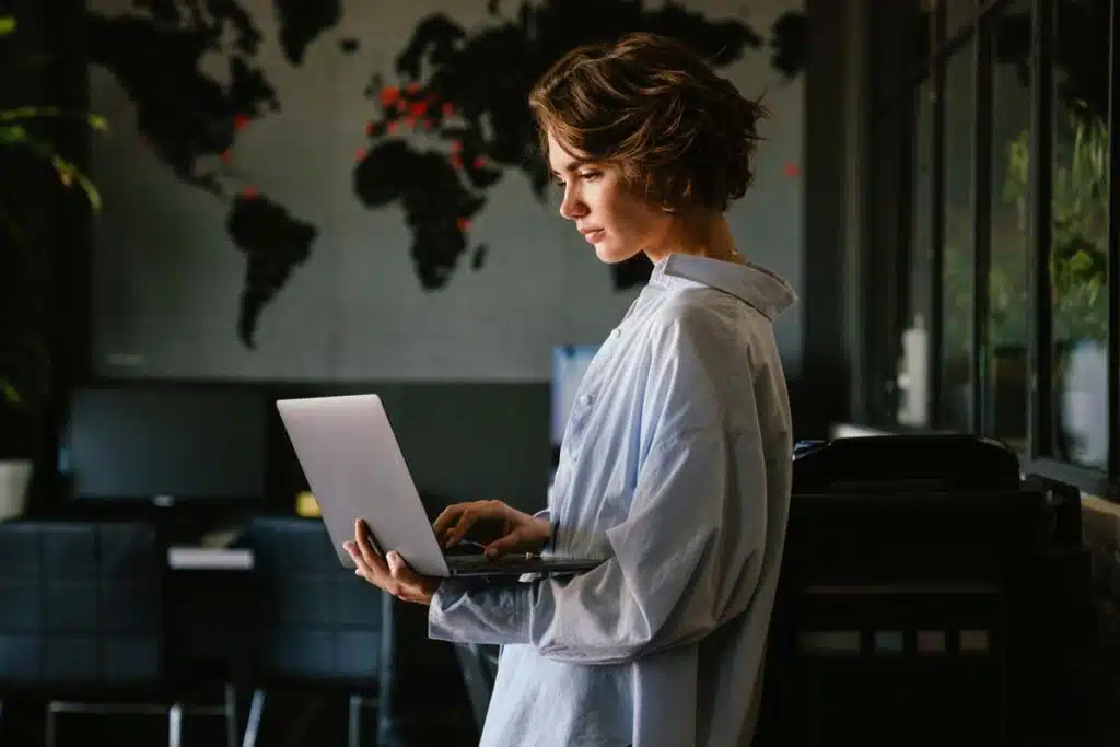 A woman using a laptop in her home, representing the Spokeo privacy class action.
