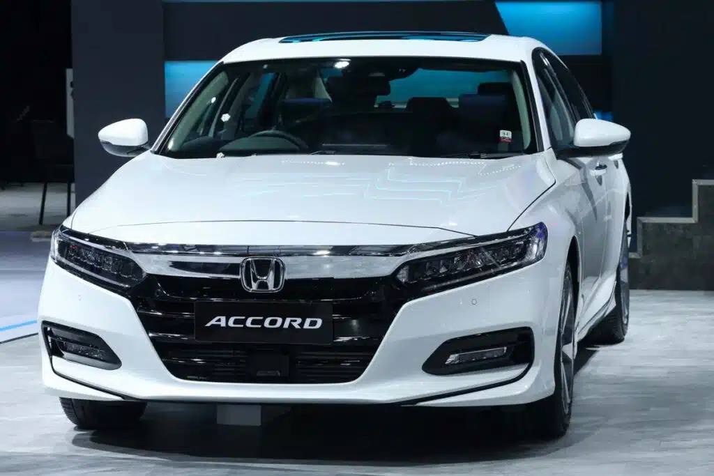 A 2023 White Honda Accord at a car show, representing the Honda seat belt recall.