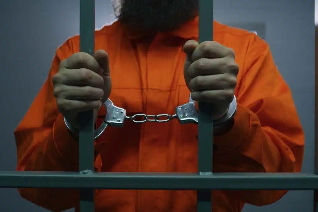 A prisoner in a jail cell, representing the St. Ann incarceration class action lawsuit settlement.