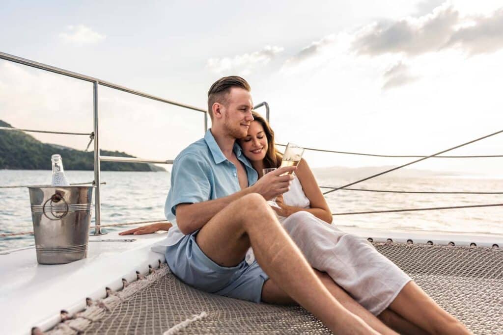 A DINK couple drinking on a yacht, representing couples with a double income and no kids.
