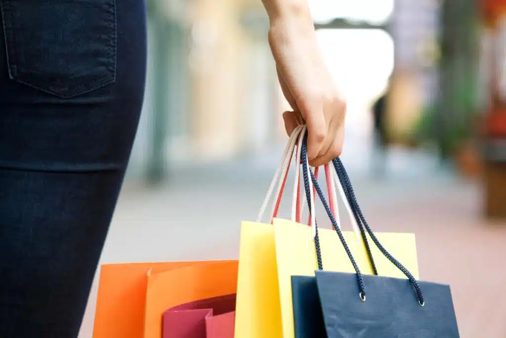 Close up of a woman holding shopping bags, representing top recalls for the week of Nov. 27.