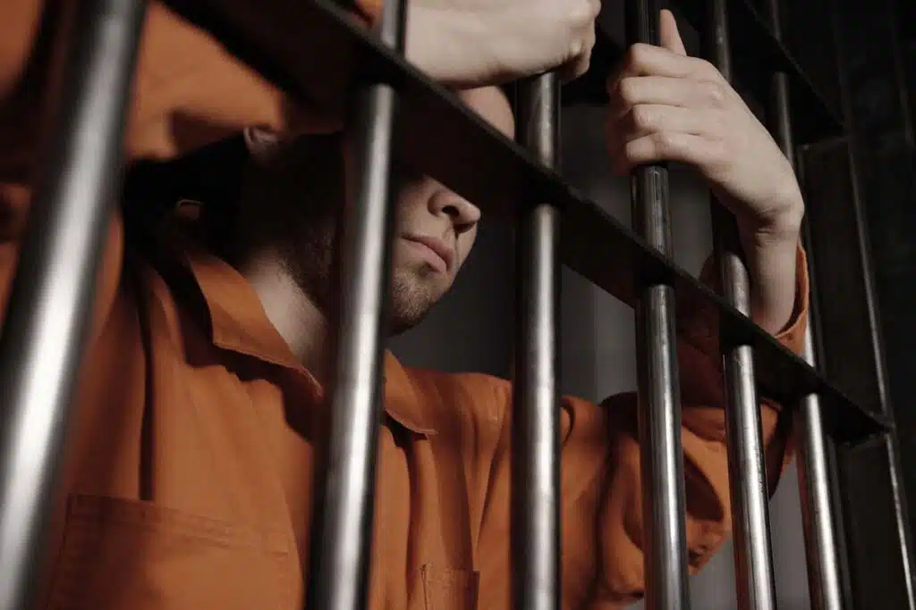 An incarcerated prisoner in a prison cell, representing the New York City Manhattan Detention Complex restrictive confinement settlement.