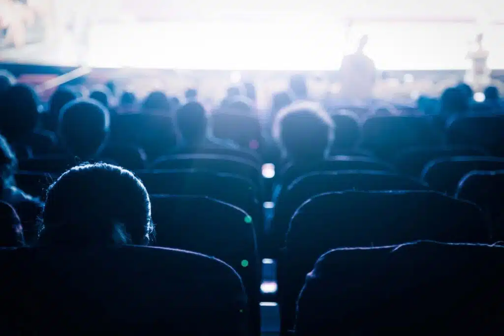 Customers sitting in a cinema, representing the Look Cinemas convenience fee class action.