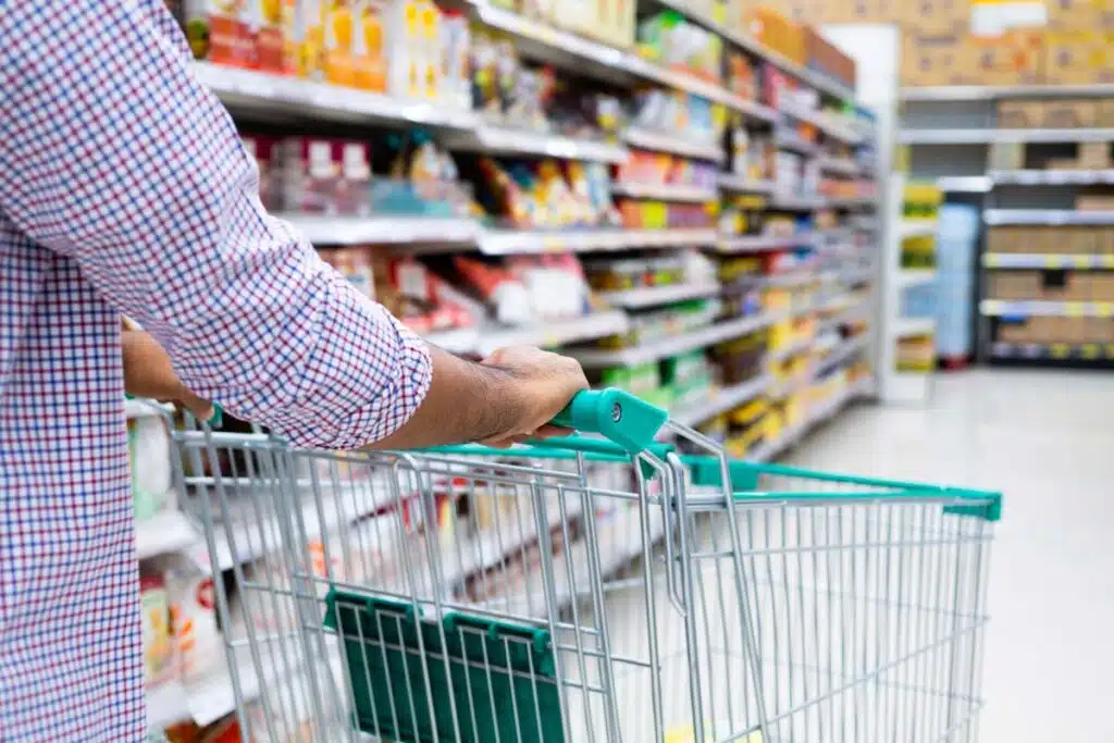 Close up of a man pushing a shopping cart in a supermarket, representing top recalls for the week of Jan. 22.