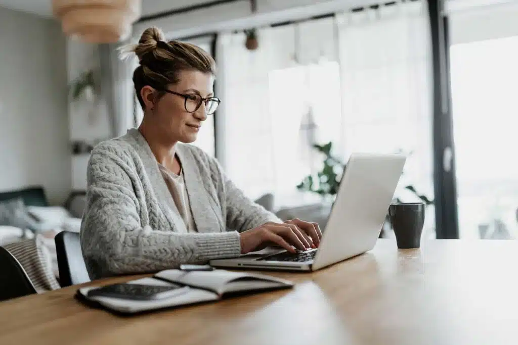 A woman typing on her laptop while working from home, representing the Amazon class action.
