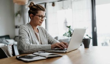 A woman typing on her laptop while working from home, representing the Amazon class action.