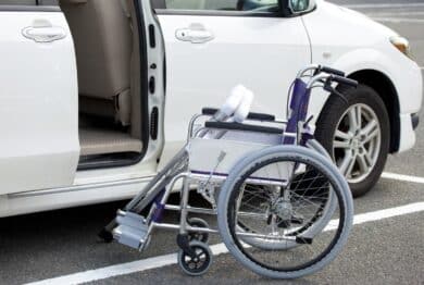 Wheelchair and crutches in front of open minivan door
