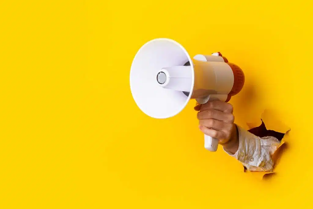 Close up of a megaphone being held through a hole in the wall, representing top recalls for the week of Dec. 25.
