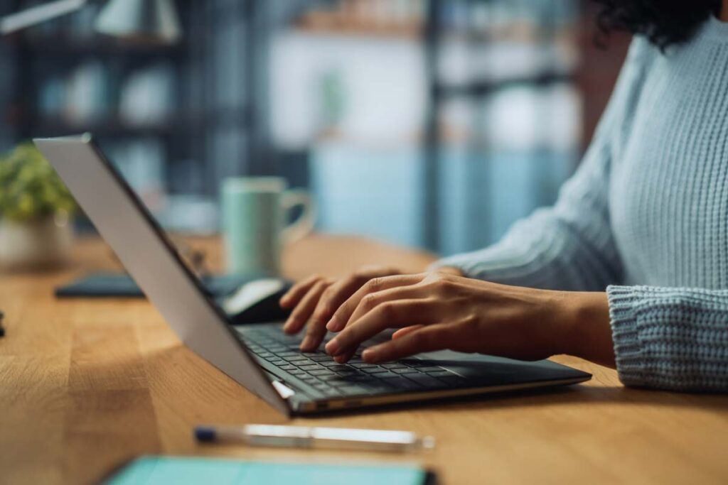Close up of a woman typing on a laptop, representing the Fidelity National Financial class action.