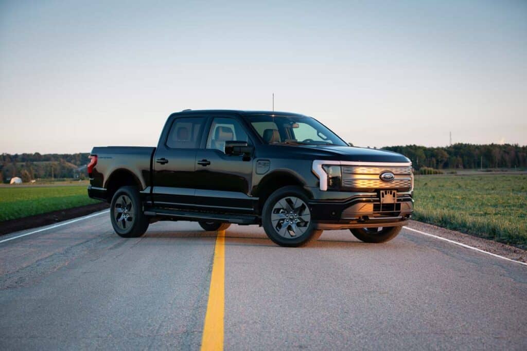 A black Ford F-150 on a roadway, representing the Ford F-150 recall.