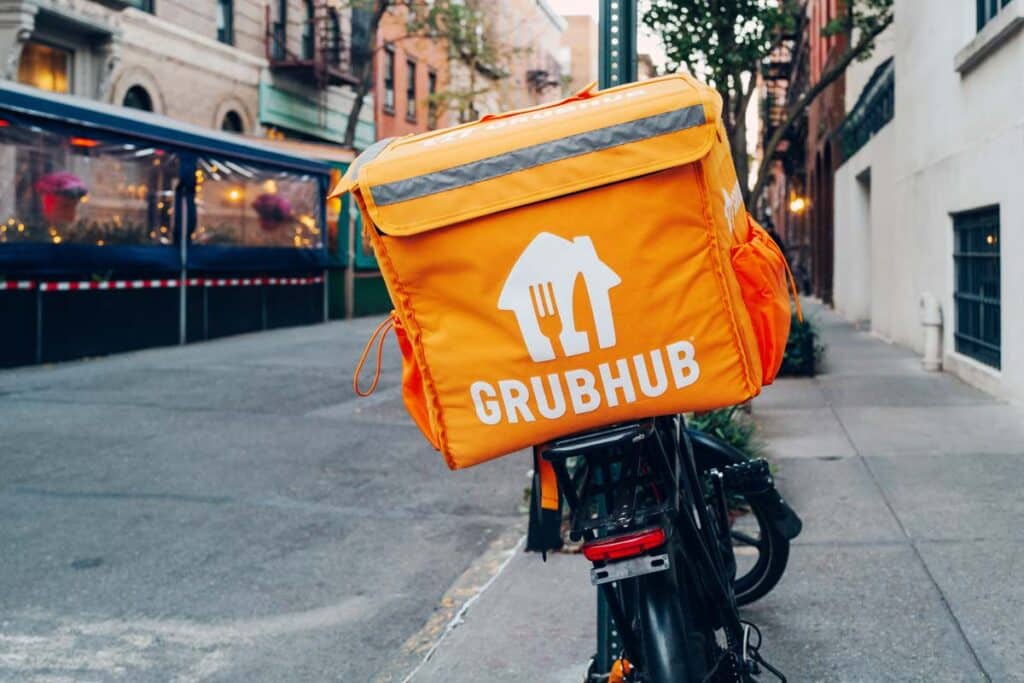 Grubhub bag on a delivery bike, representing the Grubhub overcharging settlement.