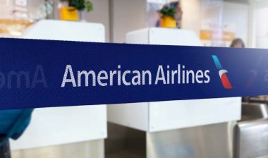 American Airlines logo on barrier tape in an airport, representing the American Airlines class action.