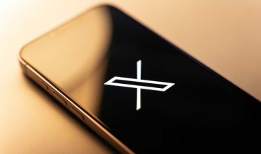 Close up of X Corp logo displayed on a smartphone screen, representing the X class action lawsuit.