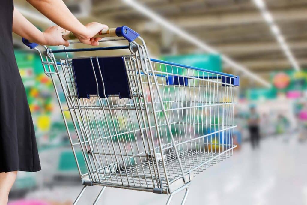 Close up of a woman pushing a shopping cart, representing top recalls for the week of Jan. 8.