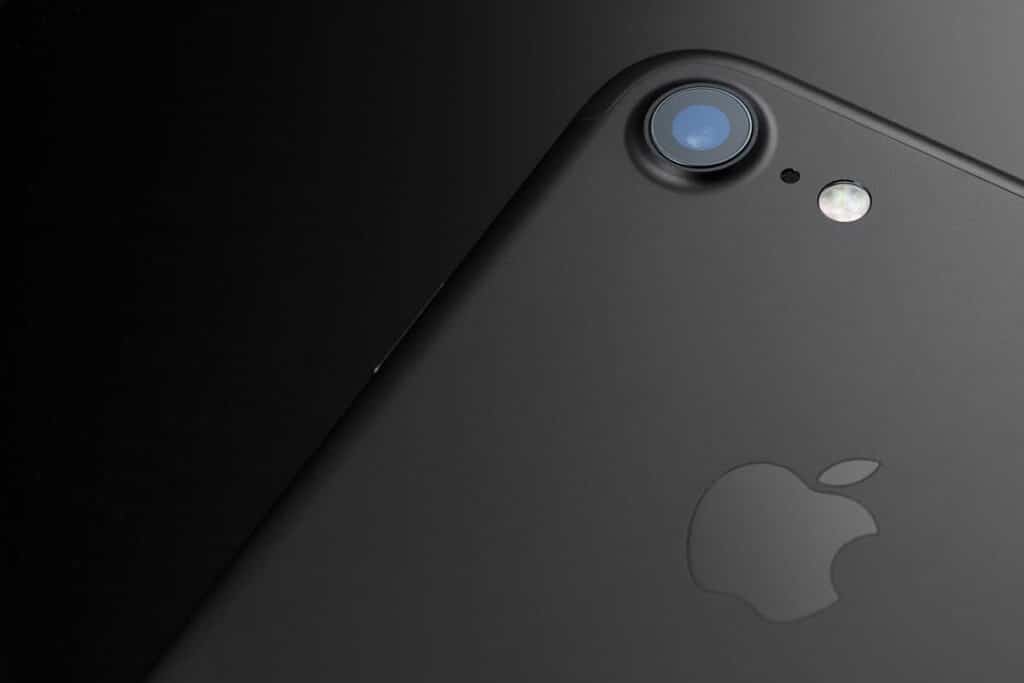 Closeup of the back of a black iPhone 7, representing the Apple audio class action lawsuit settlement.