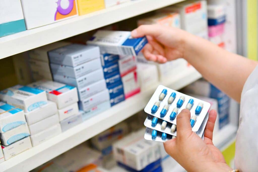 Close up of a pharmacist holding pharmaceutical drugs, representing the FDA allowance of drug imports.