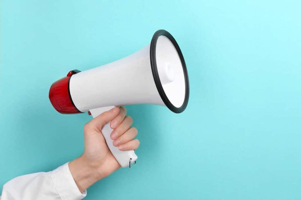 Close up of a hand holding a megaphone, representing top recalls for the week of Jan. 29.