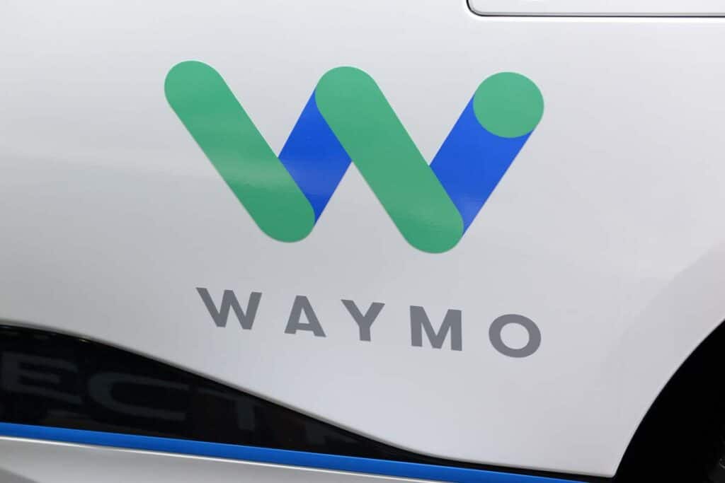 Close up of Waymo logo on the side of a vehicle, representing the Waymo recall.