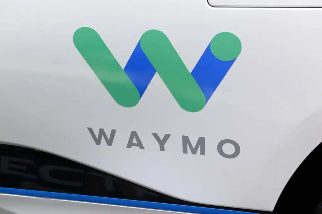Close up of Waymo logo on the side of a vehicle, representing the Waymo recall.
