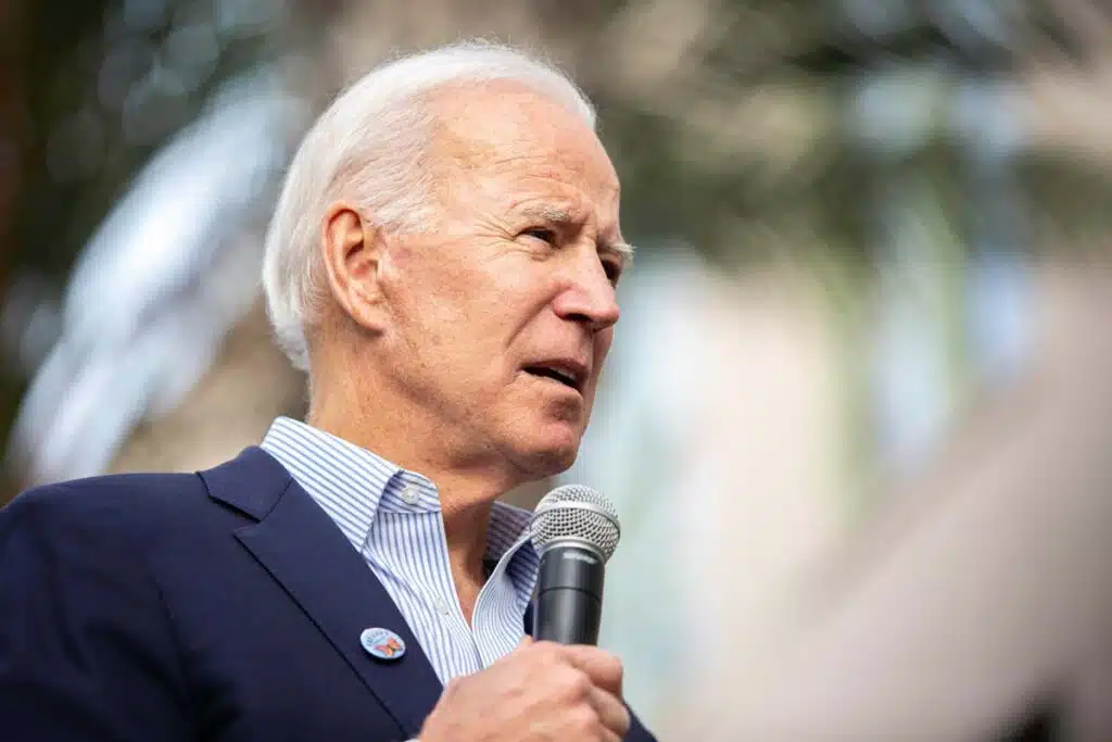 Joe Biden at an event addressing a crowd, representing student loan debt cancellation.