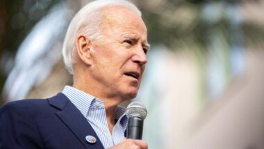 Joe Biden at an event addressing a crowd, representing student loan debt cancellation.