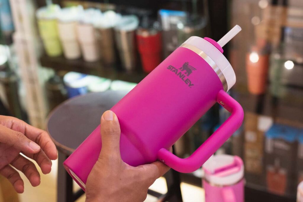 Close up of a woman holding a pink Stanley cup, representing the Stanley cups lead class actions.