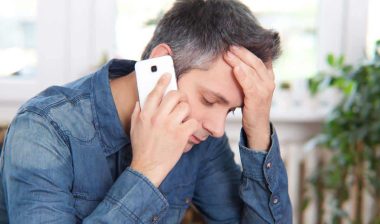 Close up of a stressed man on a phone call, representing the FiveStrata and First American settlement.