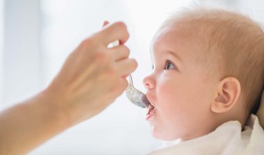 Close up of a baby being fed baby food, representing the baby food class actions.