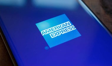 Close up of an American Express logo displayed on a smartphone, representing the American Express class action.