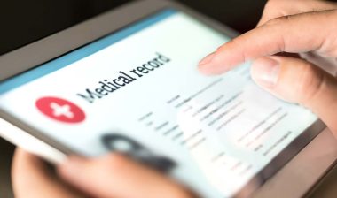 Close up of medical record displayed on a tablet, representing the Infinity Healthcare settlement.