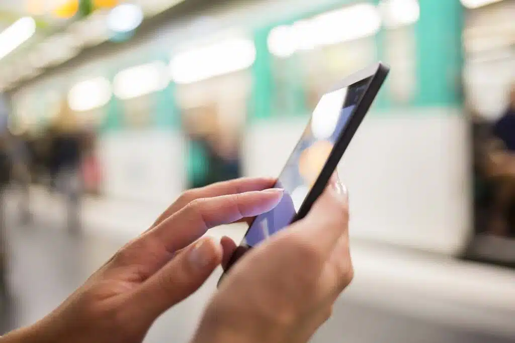 Close up of a woman using her smartphone, representing the First Financial Credit Union settlement.
