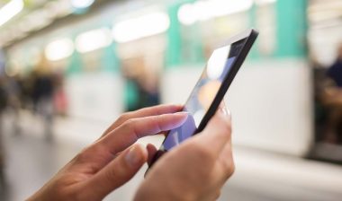 Close up of a woman using her smartphone, representing the First Financial Credit Union settlement.