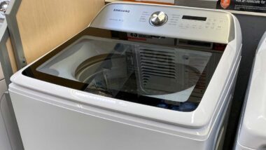 Close up of a Samsung top loading washing machine on display at a store, representing Samsung class action.