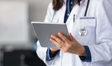 Close up of a female doctor using a tablet, representing the Roper St. Francis Healthcare data breach settlement.